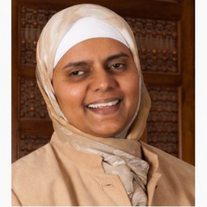 Rabia Khedr, wearing a hijab, smiles into the camera.