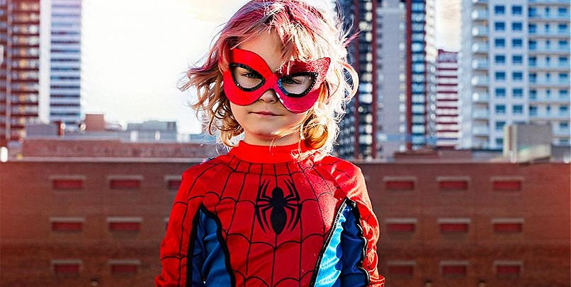 A girl dressed in a Spider-Man costume.