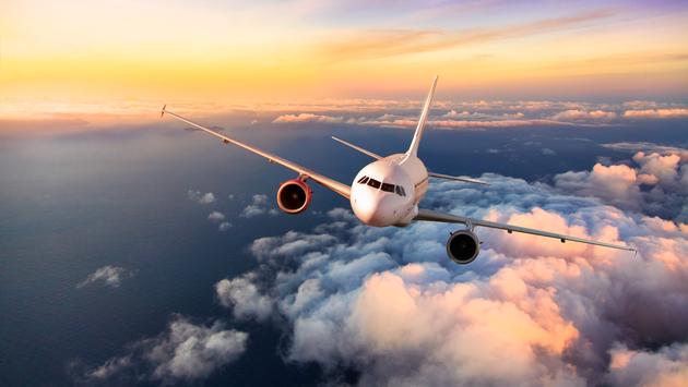 A plane flying in the sky above the clouds