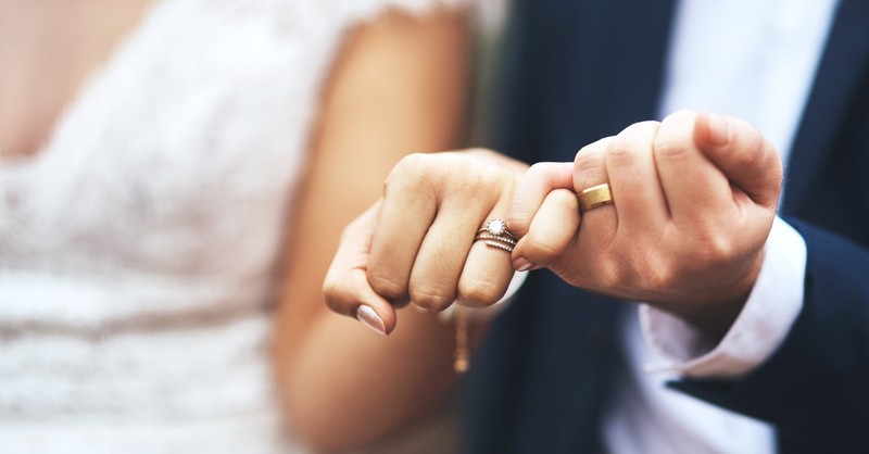 A couple showing off their wedding rings