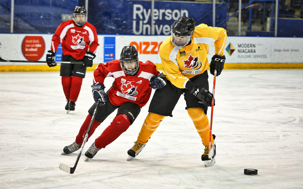 Two players battling for the puck in blind hockey