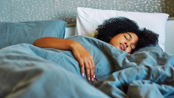 A woman sleeping in a bed