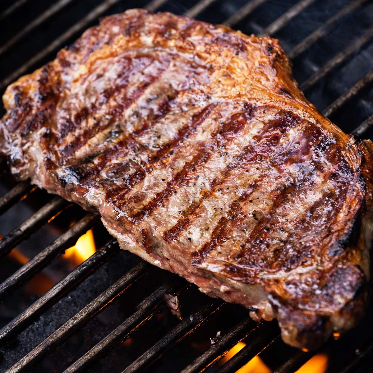 A ribeye steak on the grill