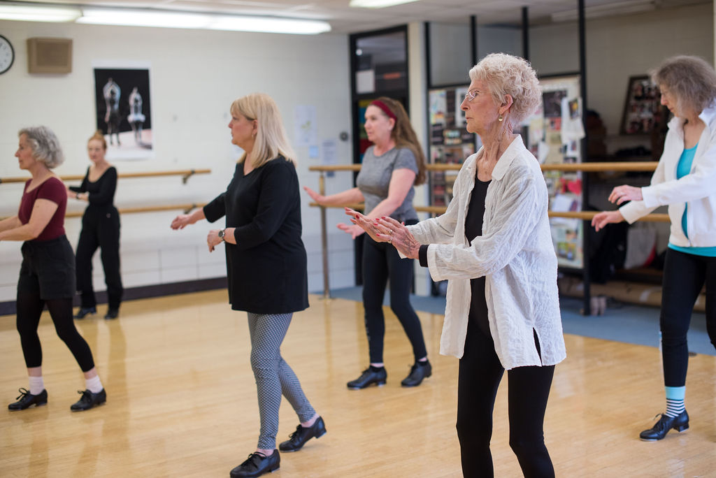 A group of people dancing in a studio