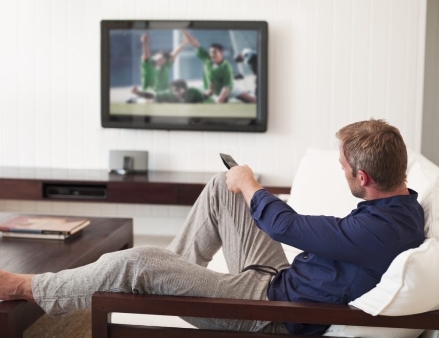 A man watching sports on TV