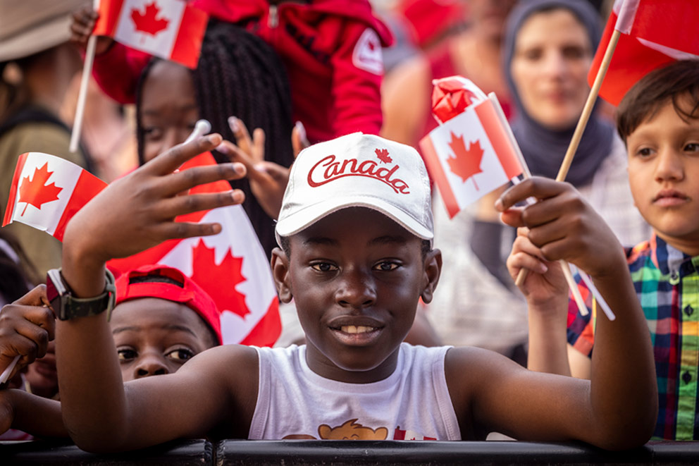 A little boy with Canadian flags all over him