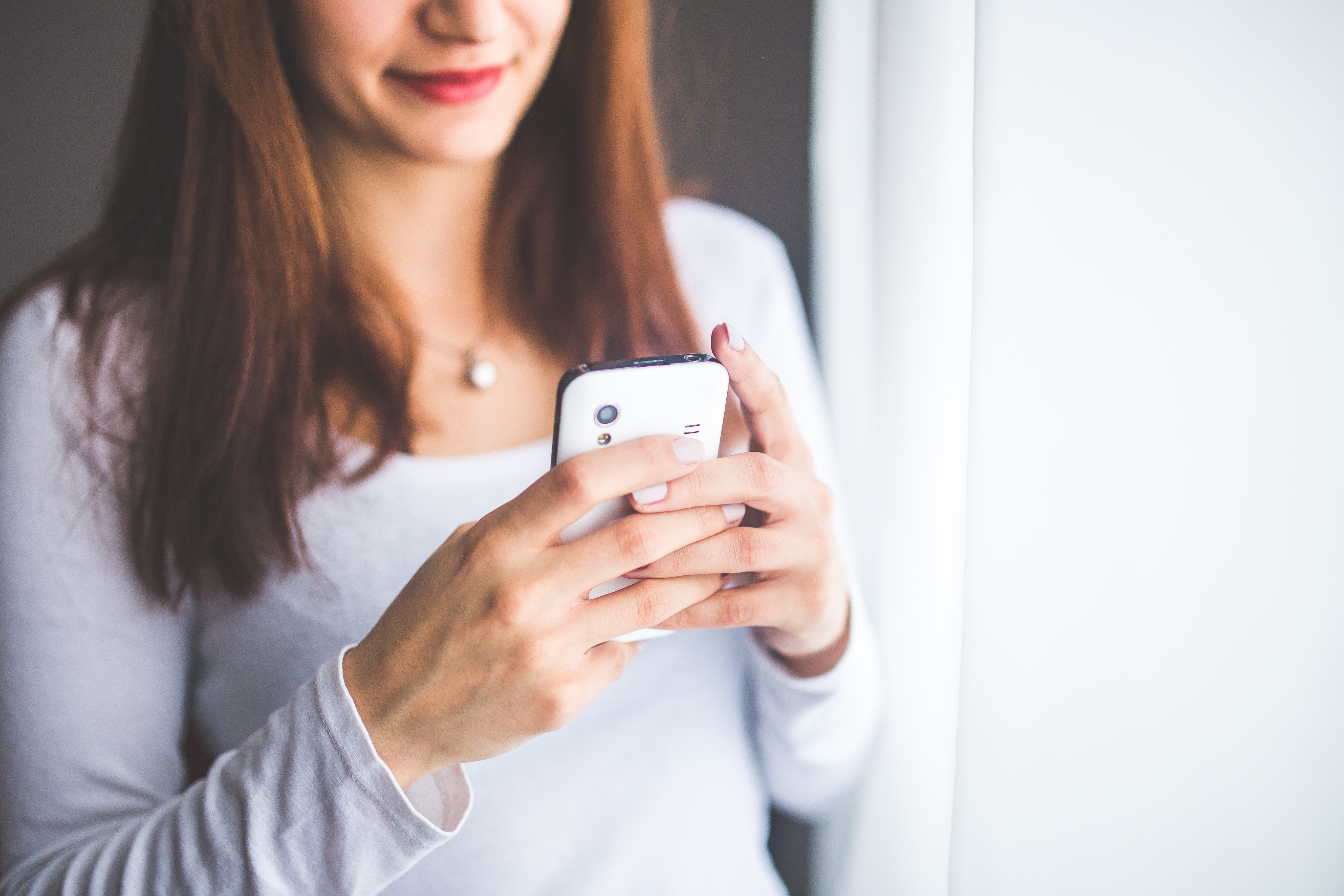 A woman texting on a phone