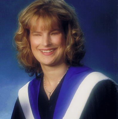 A graduation picture of Holly Bartlett. She is smiling into the camera.