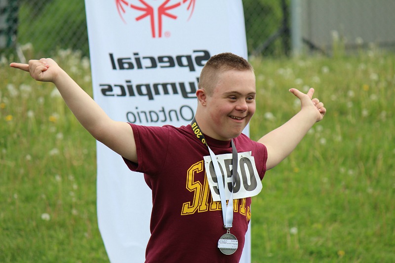 An athlete celebrates crossing the finish line.